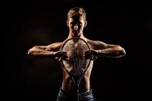 High School Senior Boy with Tennis Racket